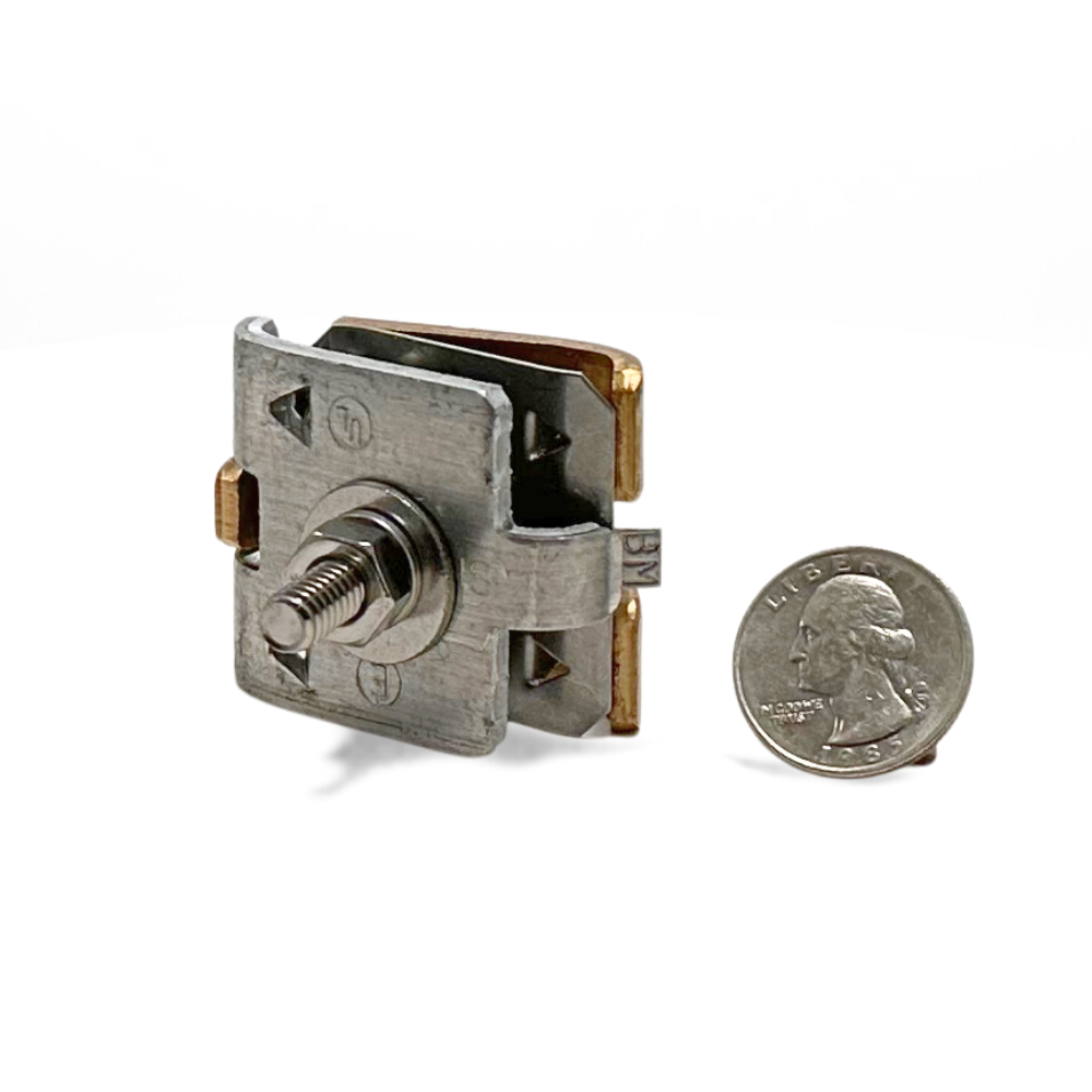 Stamped Bolted Parallel Cable Splicer shown with a quarter for size reference. Crafted from durable aluminum, this splicer is essential for connecting parallel cables up to 4/0 in lightning protection systems, meeting UL Listed Lightning Protection standards and ensuring reliability in both Residential and Commercial applications. Provided by American Rod Company.