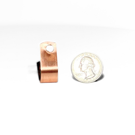 Copper loop type cable fastener next to a quarter, demonstrating size; essential for electrical grounding, aligns with LPI 175 specifications by American Rod Company.