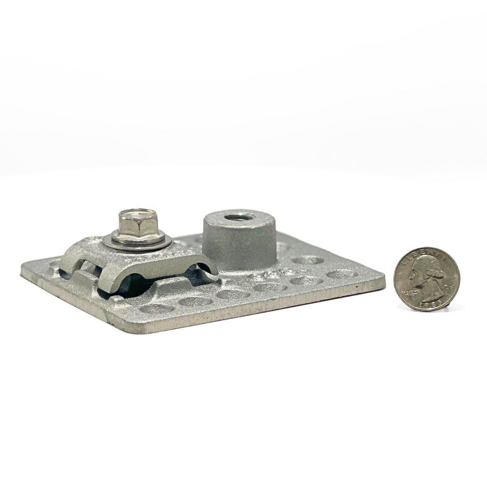 The Heavy Cast Aluminum Adhesive Point Base shown with a quarter for size reference, illustrating its compact yet durable design. This base is perfect for built-up tar and gravel or membrane roofing applications, ensuring secure lightning protection and grounding provided by American Rod Company.