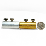 In this photo, American Rod Company’s In-Line Bi-Metallic Cable Connector is shown next to a quarter for size reference. Designed for connecting copper and aluminum cables, this connector features a 1” diameter and employs a two-bolt tension grip system using 5/16” stainless steel bolts. Ensures a durable and corrosion-resistant connection. UL Listed and NFPA 780 compliant.