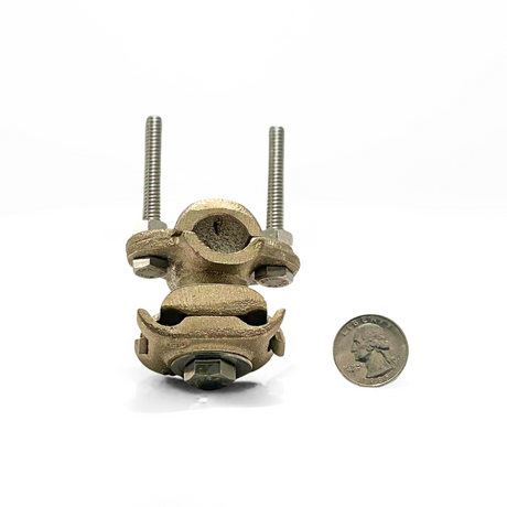 The Cast Bronze Pipe or Rebar Bonding Clamp shown with a quarter for size reference illustrates its compact yet robust design. Perfect for secure connections in lightning protection and grounding systems by American Rod Company.