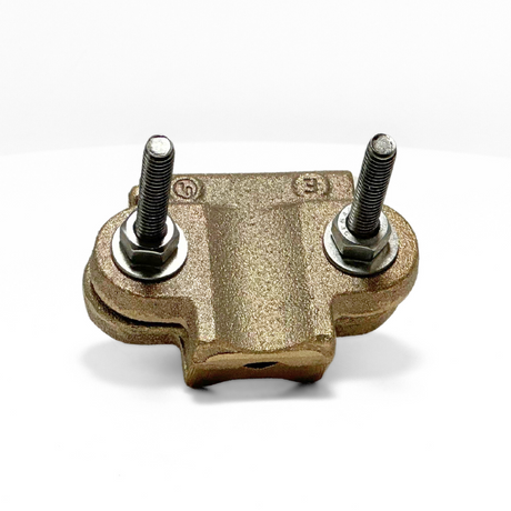 This angled photo showcases American Rod Company’s Copper Pipe Bonding Clamp. Engineered for superior performance in lightning protection systems, this cast copper pipe bonding clamp secures main-sized cables to pipes. Dual stainless steel U-style bolts allow for easy tension adjustment, ensuring a durable connection. UL 96A and LPI 175 certified.