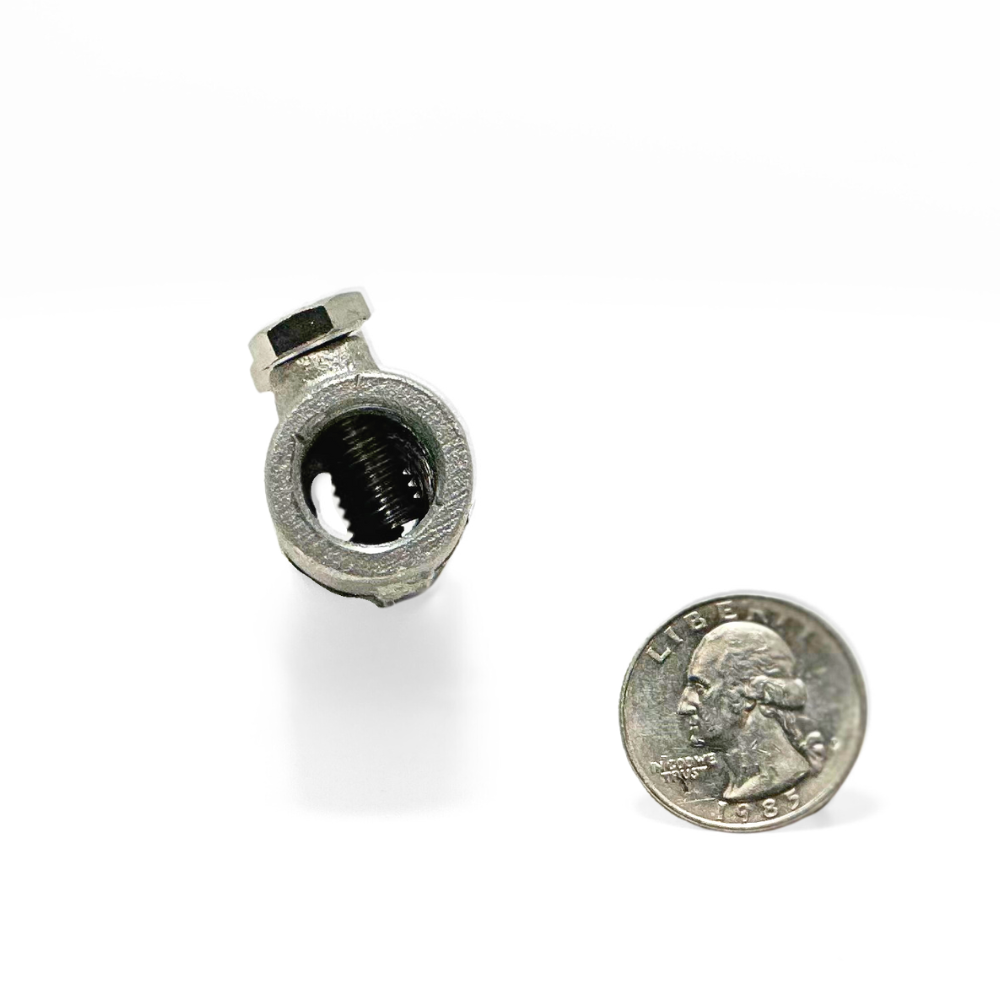 Detailed view of the cable end of American Rod Company’s Cast Aluminum Straight Point Base/Splicer next to a quarter, showcasing where Class I aluminum cables securely attach, highlighting the firm and reliable connection crucial for effective lightning protection